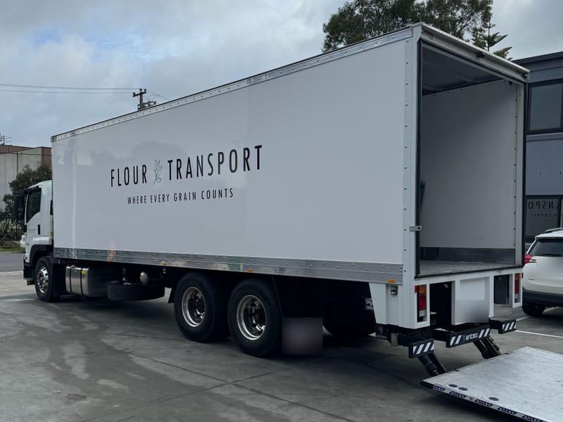 Rear of our Flour Transport truck with the tailgate lifter down, ready to unload